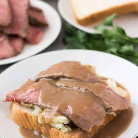 Leftover Pot Roast Sandwich Warm gravy has been poured over the open faced sandwich.