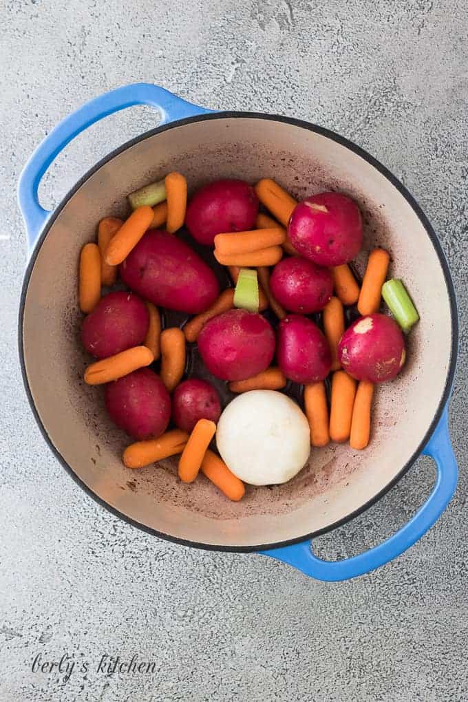 The pan has been deglazed and veggies have been added.