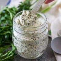 A small spoon showing a scoop of ranch dressing mix.