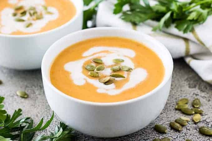 Acorn squash soup topped with toasted seeds and coconut milk.