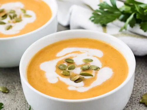 The instant pot acorn squash soup drizzled with coconut milk.