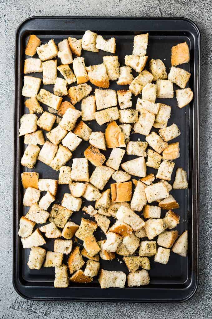 The croutons on a large sheet pan just before baking.