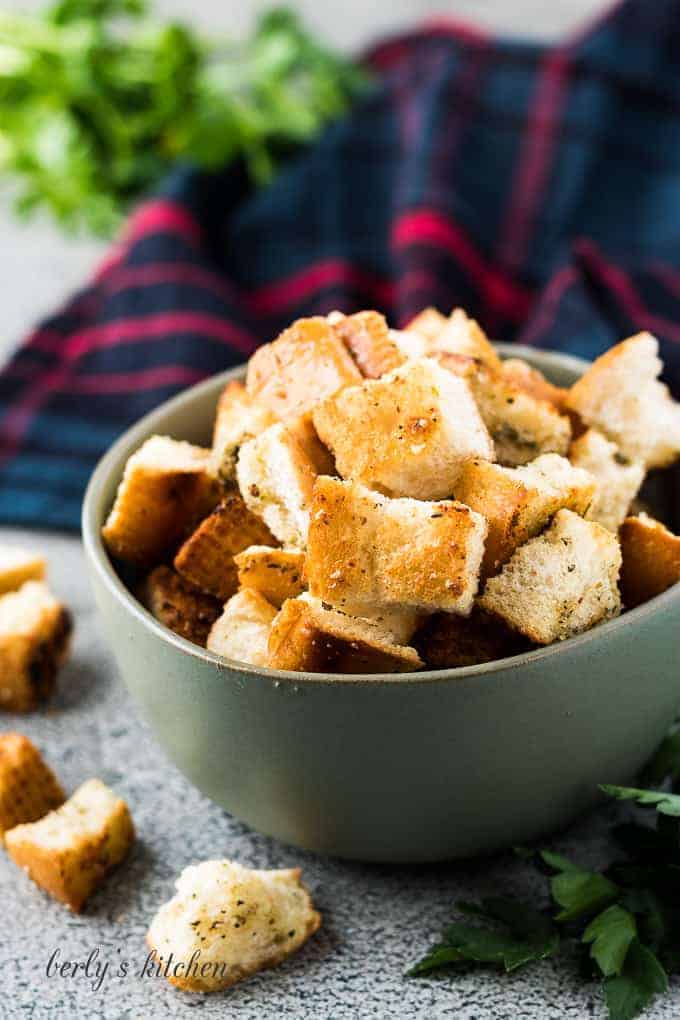 A close-up of the finished croutons in a green bowl.