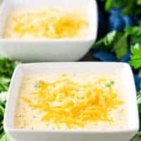 Two square bowls filled with the finished broccoli cheese soup.