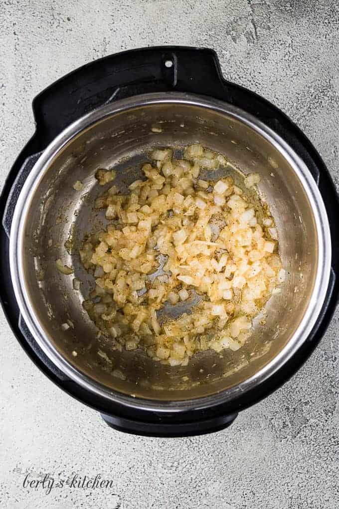 Diced onions and minced garlic sauteed in the pressure cooker.