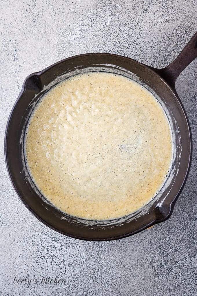 Butter, flour, and other ingredients cooking in the iron skillet.