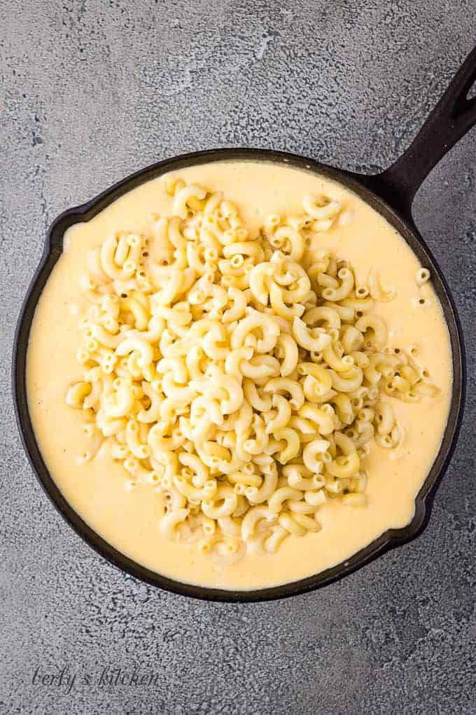 Cooked macaroni noodles added to the cast iron skillet.