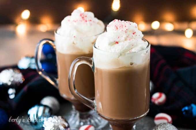 Two glasses of peppermint mocha topped with homemade whipped cream.