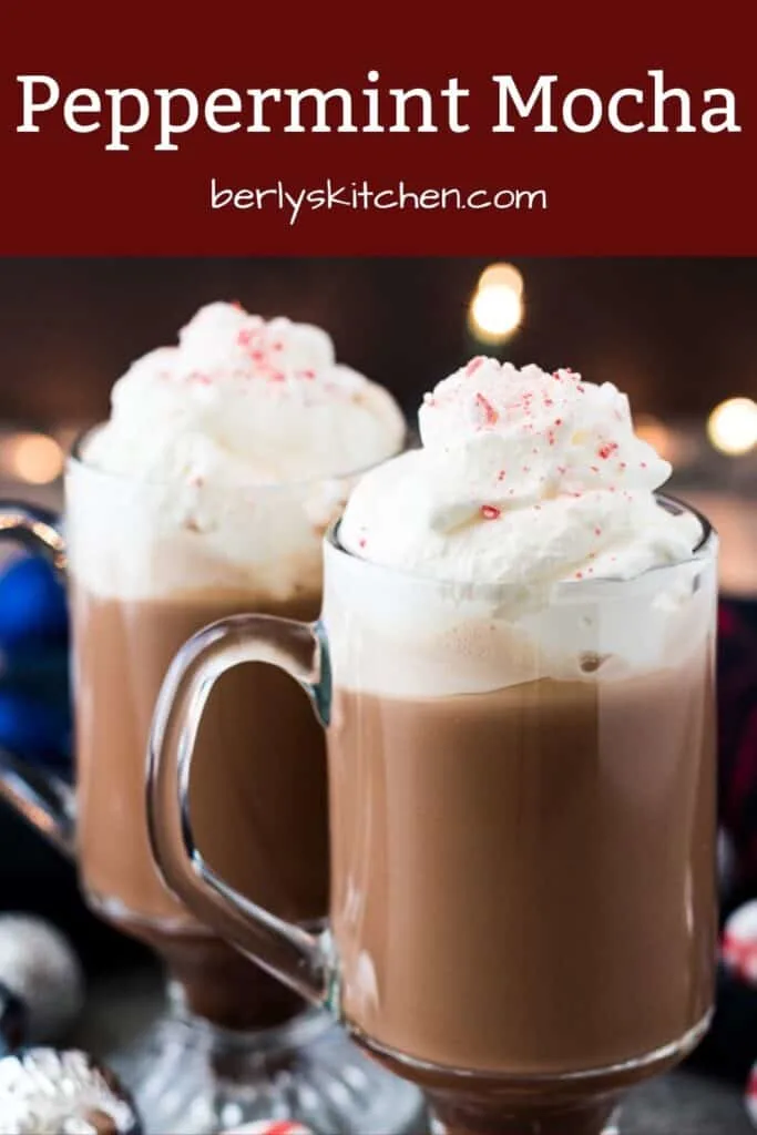 Two peppermint mocha coffees topped with whipped cream and ground peppermint.