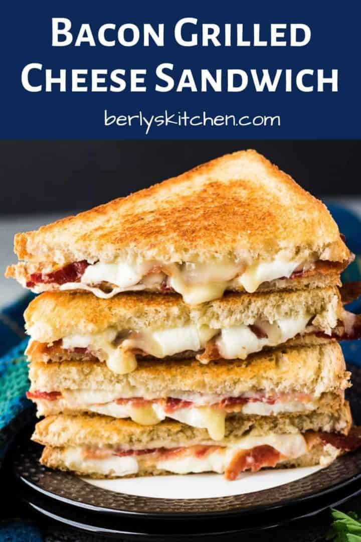 Two bacon grilled cheese sandwiches stacked on a decorative plate.