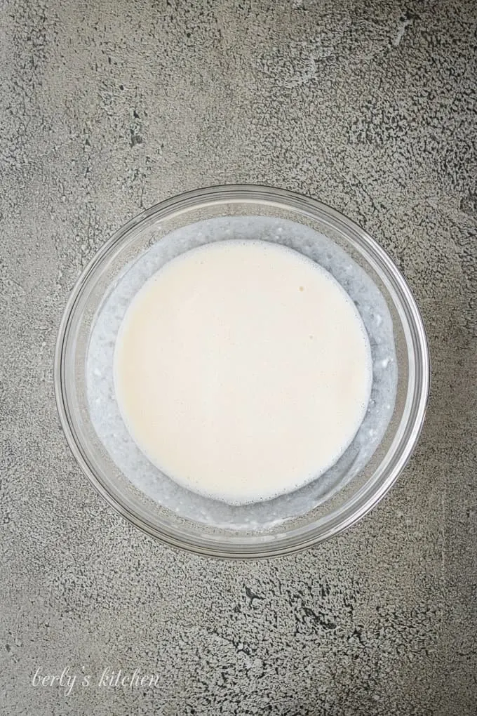 Ariel view of milk and flour in a glass bowl.