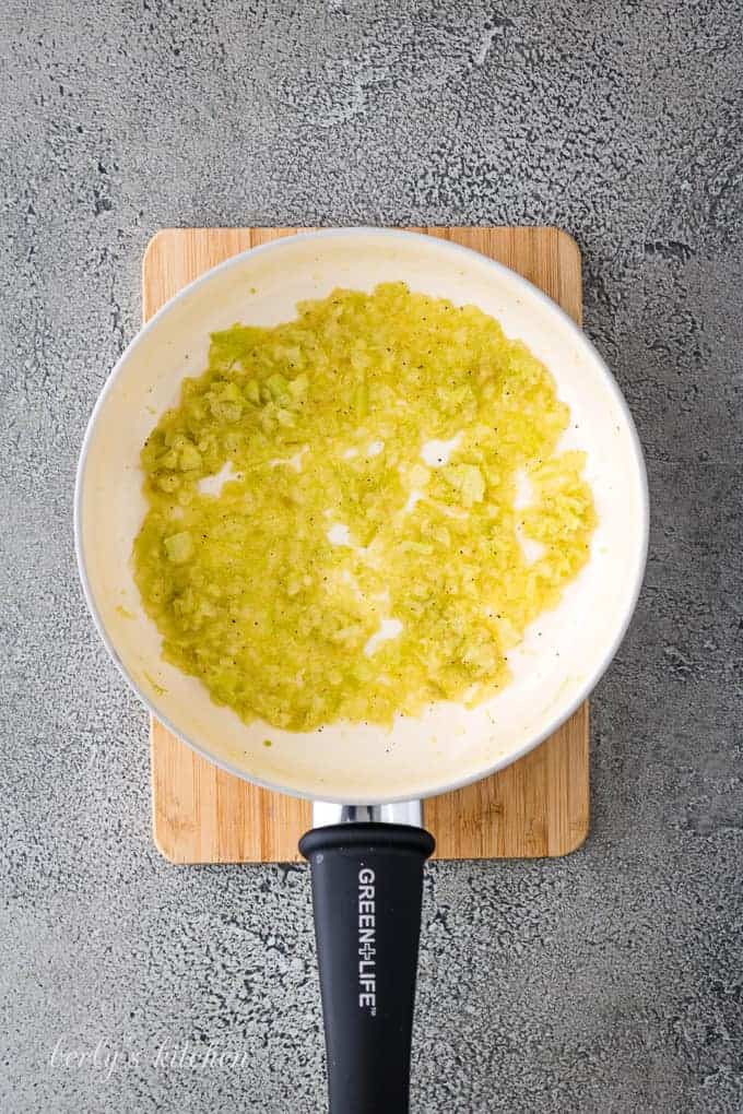 Arial view of celery, spices, and butter in a saucepan.