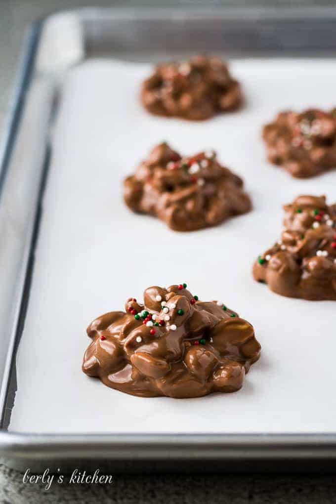 The candies has been formed on a lined baking sheet.