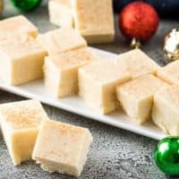 Multiple pieces of eggnog fudge on a plate.