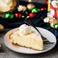 A slice of the eggnog pie surrounded by festive decorations.