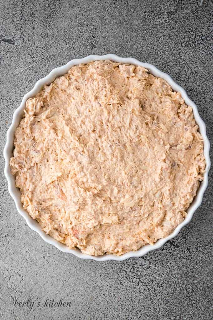 The crab dip has been transferred to a tart pan.