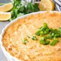 The crab dip has baked and topped with green onions.