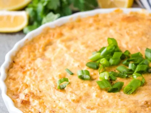 The crab dip has baked and topped with green onions.