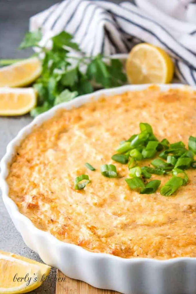 The crab dip has baked and topped with green onions.