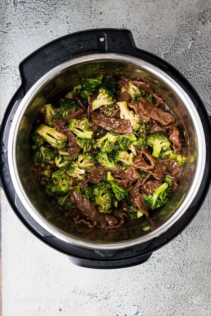 Steamed broccoli has been stirred into the beef and sauce.