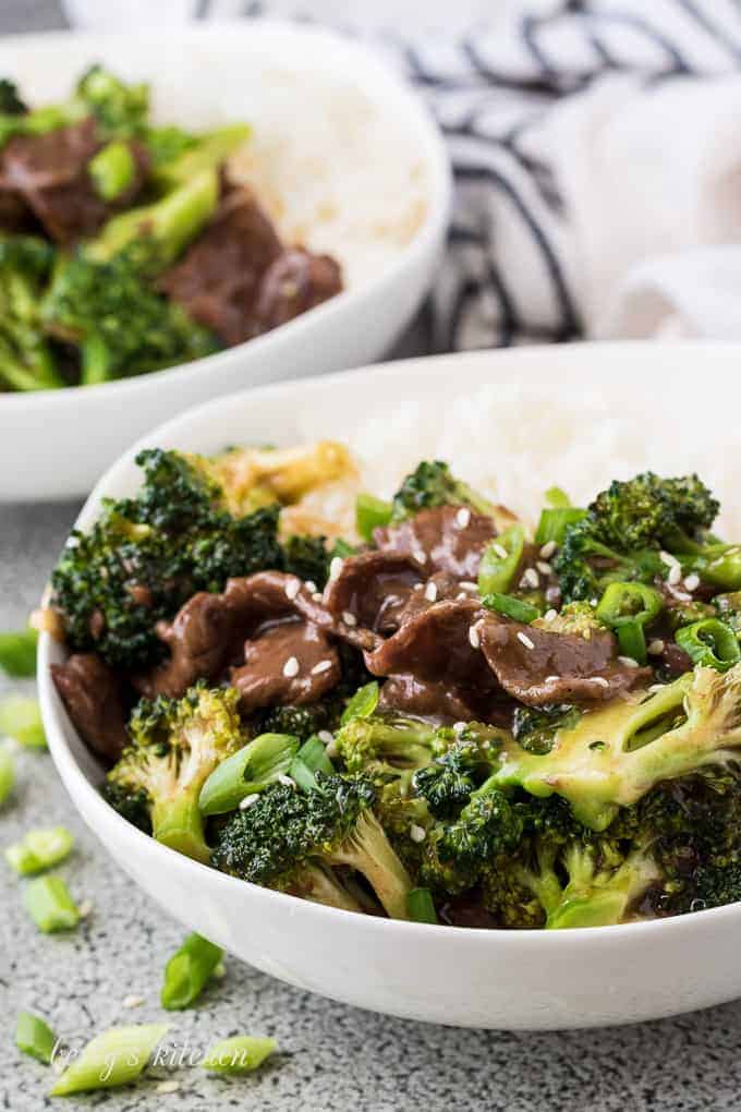 Two bowls of instant pot beef and broccoli served with steamed rice.