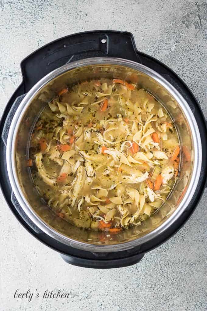 The chicken breast has been shredded and returned the liner.