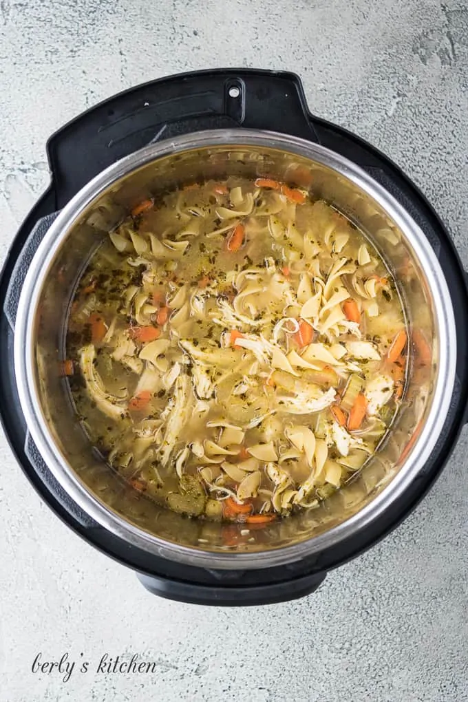 The chicken breast has been shredded and returned the liner.