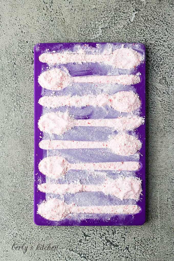 The silicone mold has been filled with crushed peppermint candies.