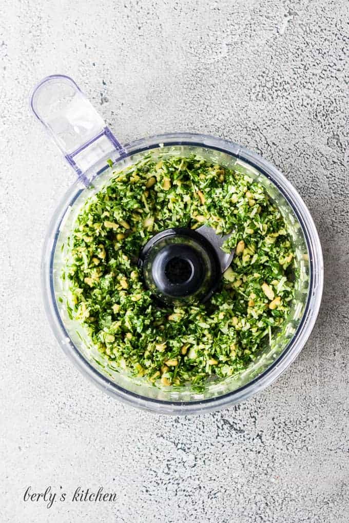 The basil and pine nuts have been pulsed in the processor.