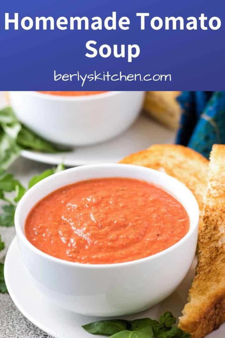 Tomato basil soup in a bowl served with a grilled cheese sandwich.