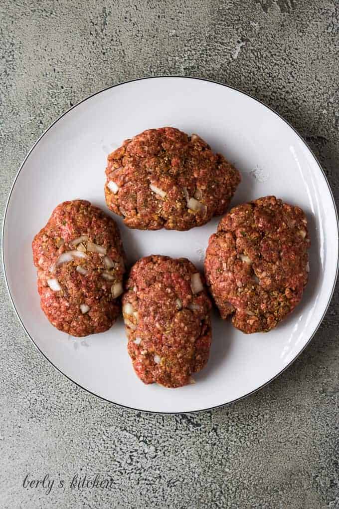 The beef mixture has been formed into four Salisbury steaks.