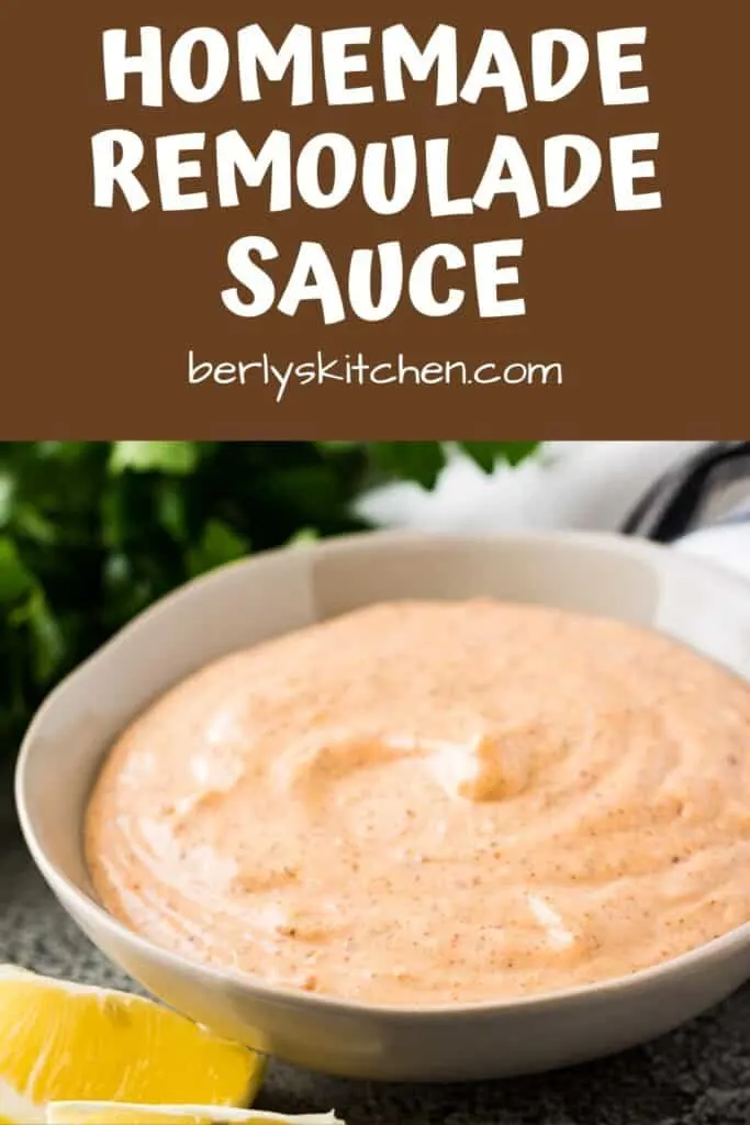 A bowl of the remoulade sauce served with lemon wedges.