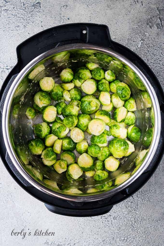 The cooked Brussel sprouts and melted butter have been stirred.
