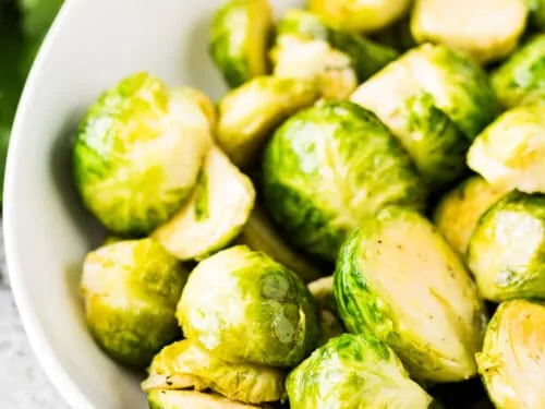 A close-up view of the buttered sprouts in a bowl.