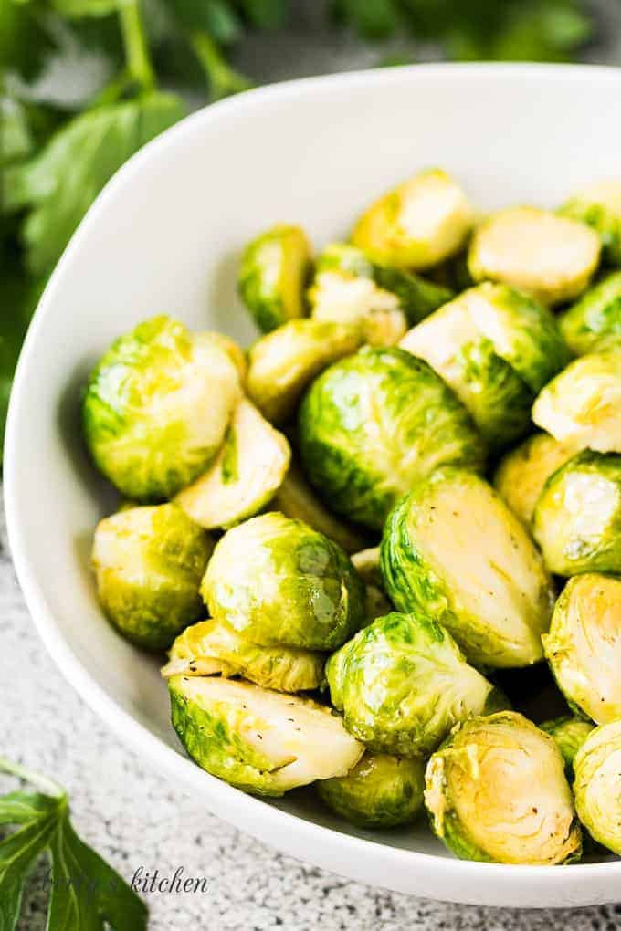 A close-up view of the buttered sprouts in a bowl.