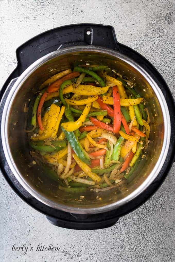 Bell peppers, onions, and garlic sauteing in the instant pot.