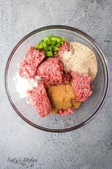 Ground beef and other ingredients in a large mixing bowl.