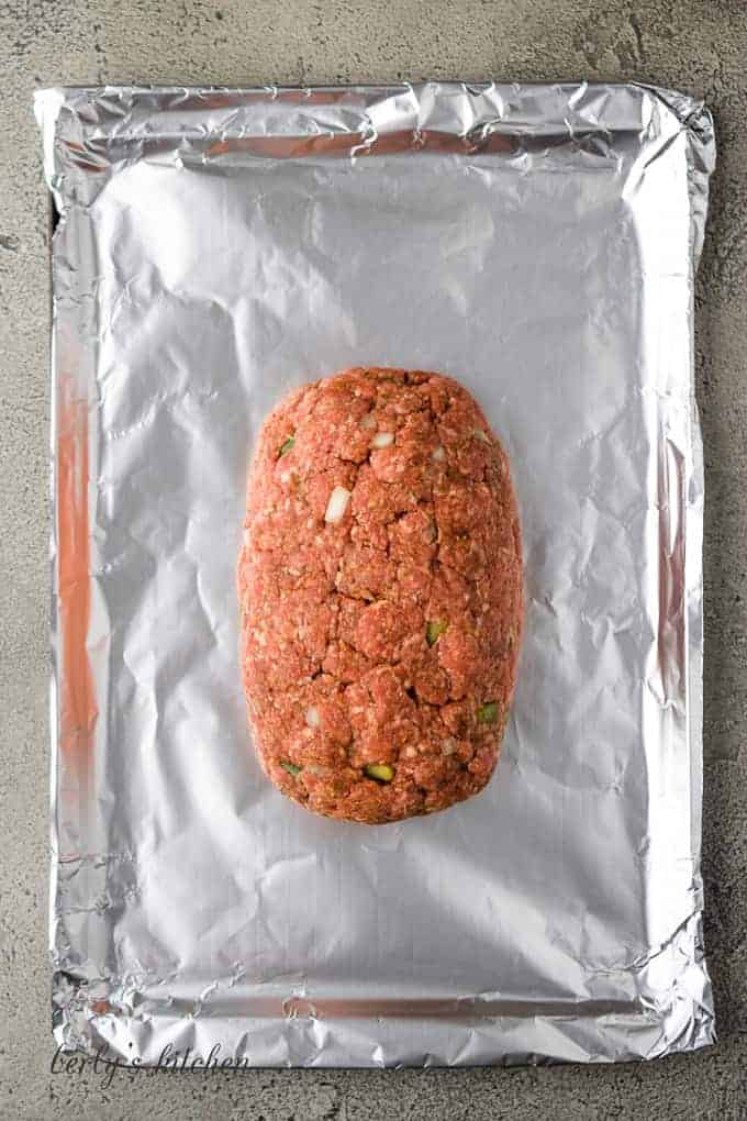 The shaped loaf has been placed on a foil-lined pan.