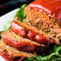 The meatloaf has been sliced and placed on a serving platter.