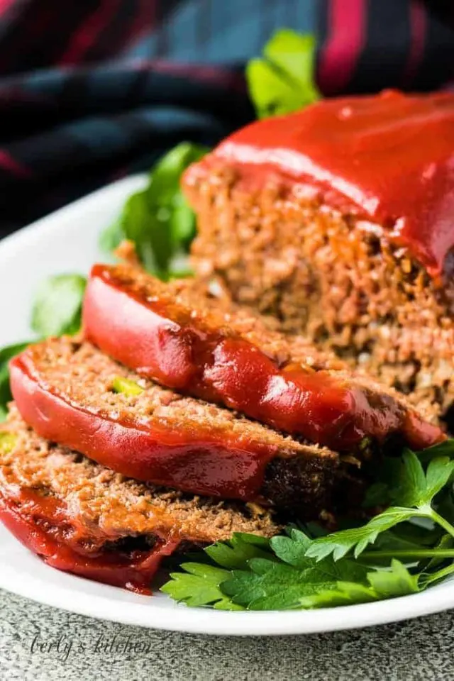 The meatloaf has been sliced and placed on a serving platter.