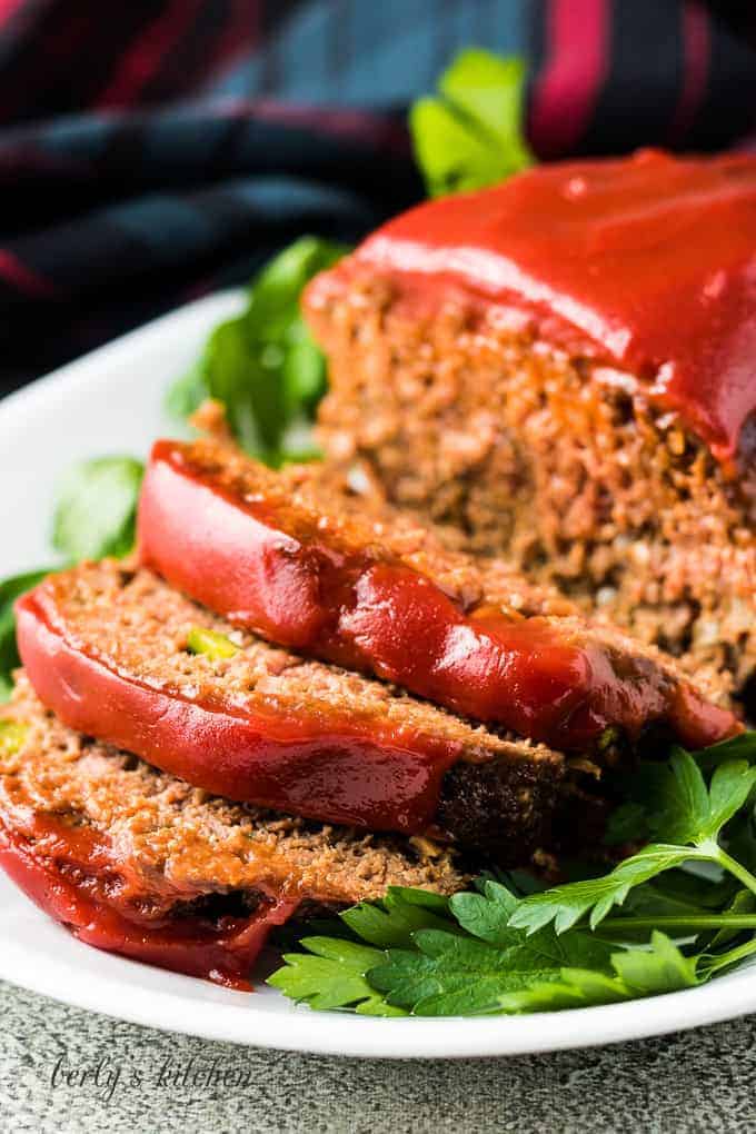 The meatloaf has been sliced and placed on a serving platter.