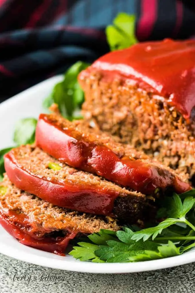 The meatloaf has been sliced and placed on a serving platter.