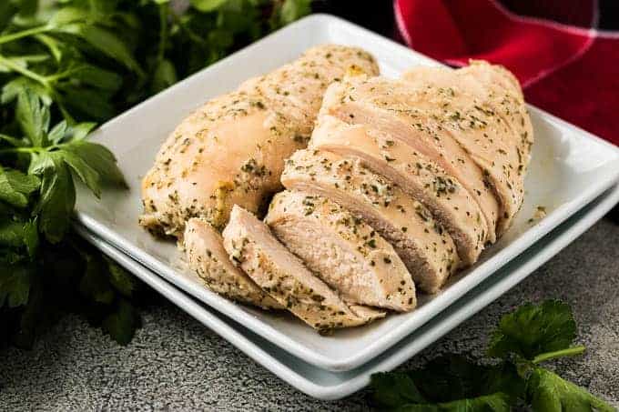 Two oven baked ranch chicken breasts sliced in a bowl.