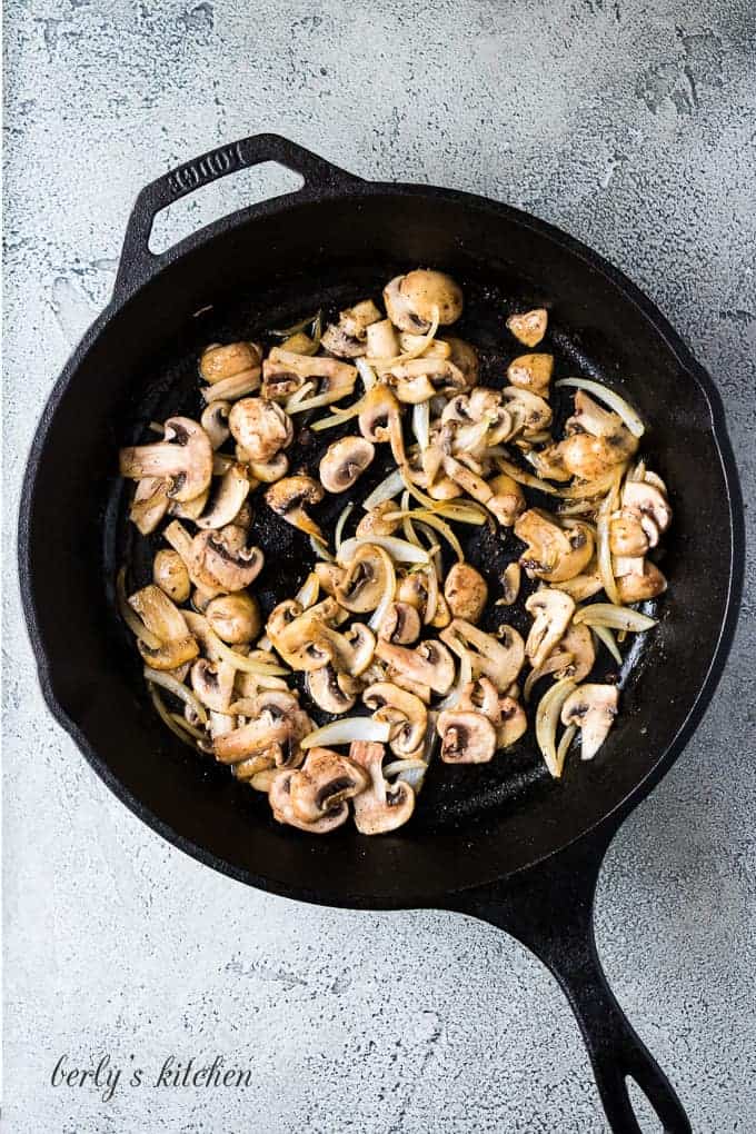 The cooked patties have been replaced with onions and mushrooms.