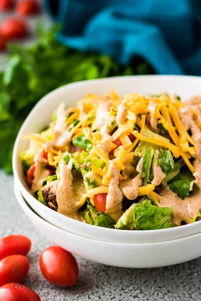 A bowl filled with Southwest chicken salad topped with dressing.