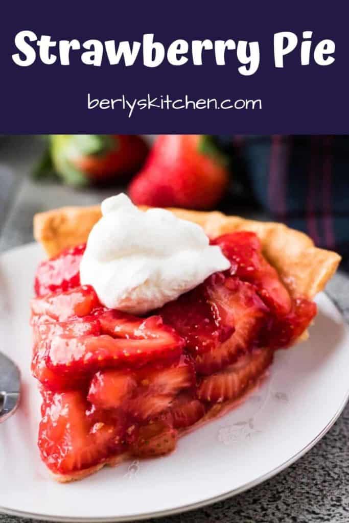 A slice of the strawberry pie topped with whipped cream.