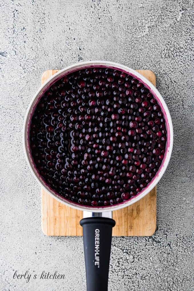 The finished blueberry sauce in a medium saucepan.