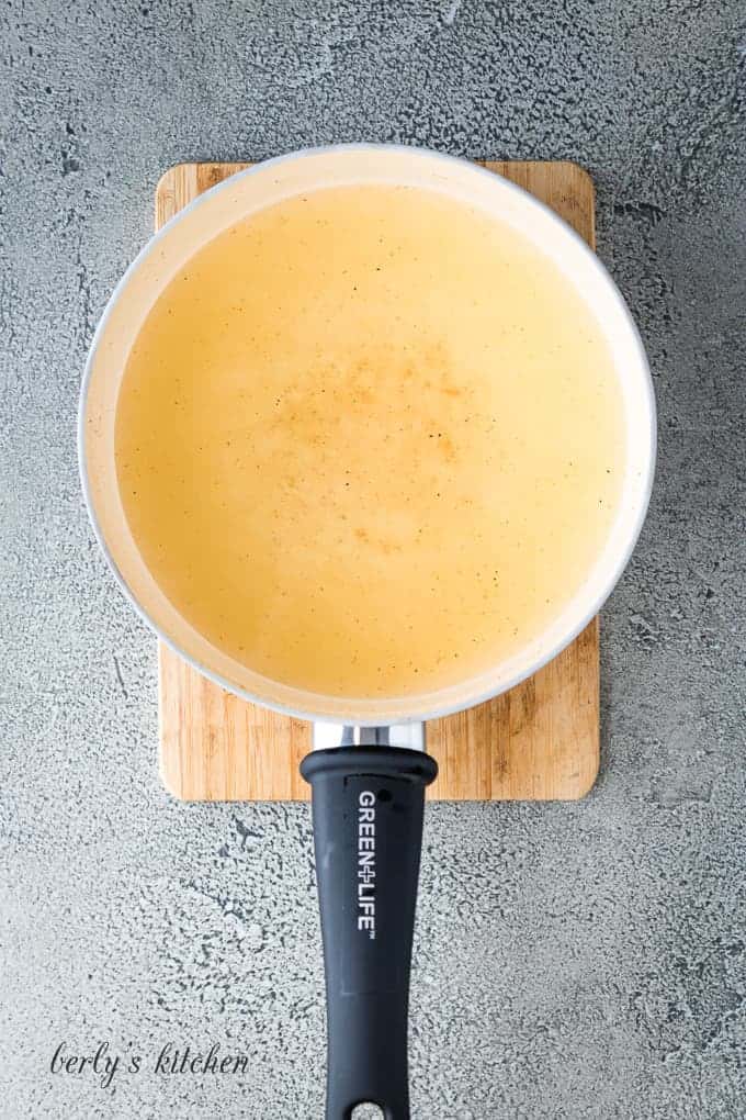 Spices and chicken broth mixed together in the small saucepan.