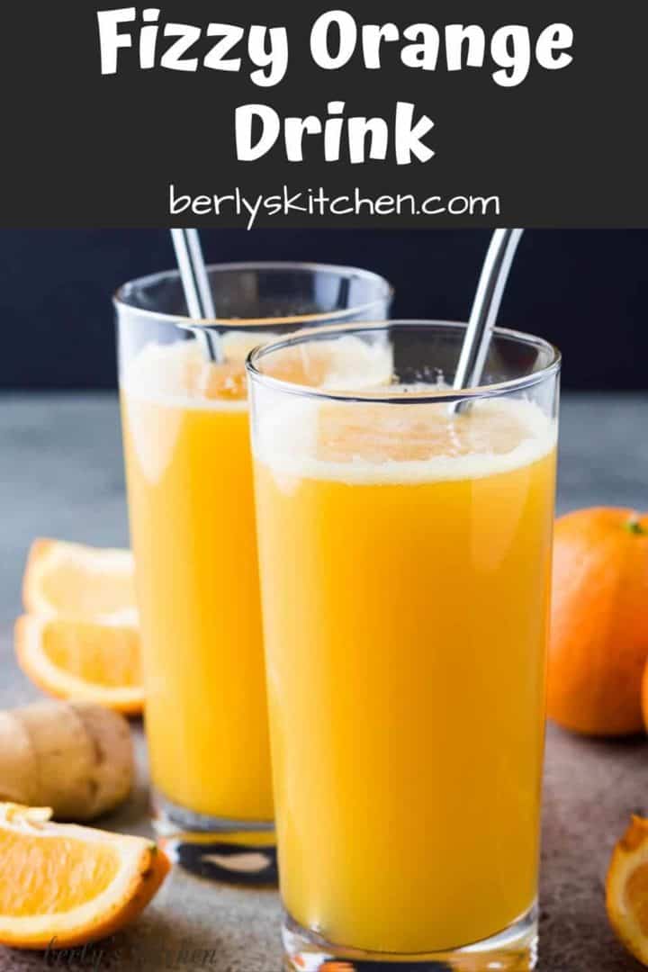 The fizzy orange drink served in glasses with colorful straws.