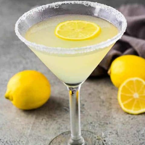 The finished martini garnished with a sugared rim and fresh lemon.